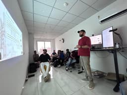 A member presenting to the room at the Coffee with Claude Entrepreneur Edition session.
