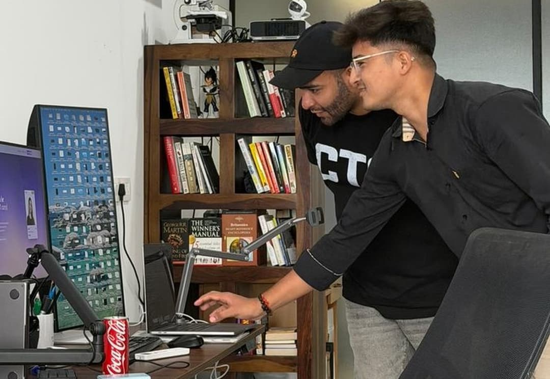 Two members reviewing a build together at the Coffee with Claude Sales Edition session.