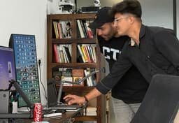 Two members reviewing a build together at the Coffee with Claude Sales Edition session.