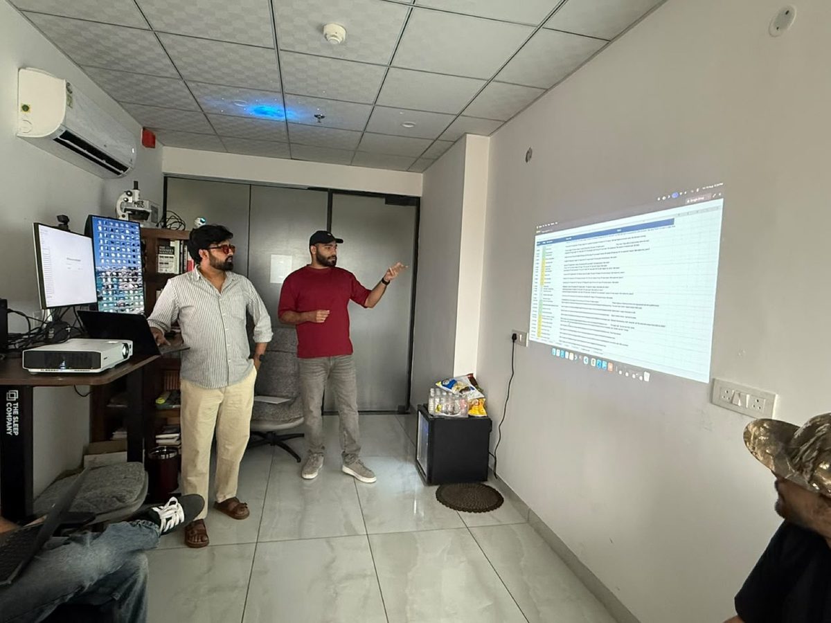 Two members presenting in front of a screen during a Build with Claude workshop in Chandigarh.